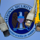An illustrated picture shows various network cables hanging in front of a computer screen showing the logo of the US National Security Agency (NSA) in an office in Schwerin, Germany.